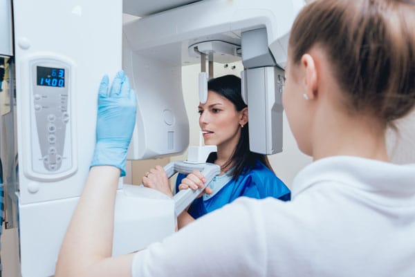 Patient receiving a digital x-ray of her mouth.