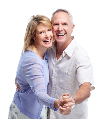 Older couple smiling with confidence after benefiting from implant retained dentures.