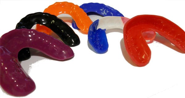 Colored mouth guards used to prevent teeth grinding during sleep.